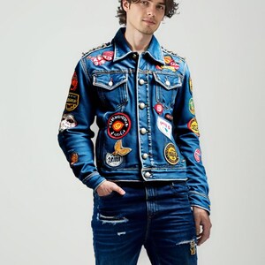 May include: A blue denim jacket with a variety of colorful patches and embellishments. The jacket has a button-up front and long sleeves.