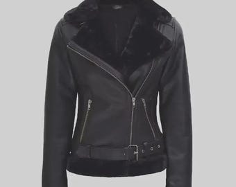 May include: Black faux leather jacket with a faux fur collar and lining. The jacket features a diagonal zipper closure, a belt at the waist, and zippered pockets. The cuffs are trimmed with faux fur. A stylish outerwear piece.