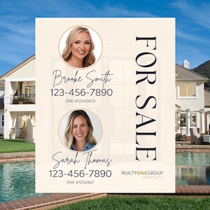 May include: A beige and white real estate sign with the words "FOR SALE" in large blue letters. The sign also includes the names and phone numbers of two real estate agents, Brooke Smith and Sarah Thomas, along with their DRE numbers. The sign also includes the logo for RealtyOneGroup Complete.