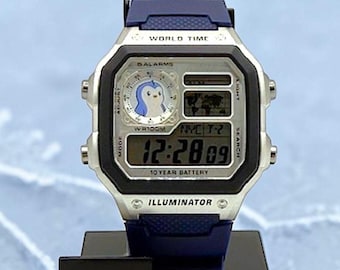 Reloj Casio AE-1200 personalizado "PENGU" inspirado en pingüinos regordetes, con diseño criptográfico | Reloj digital con hora mundial | Para fans, entusiastas y coleccionistas de PENGU | Icónico
