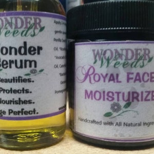 May include: Two bottles of skin care products. The bottle on the left is a clear glass bottle with a yellow liquid and a purple label that says "Wonder Weeds Wonder Serum Beautifies. Protects. Nourishes. Age Perfect." The bottle on the right is a dark glass jar with a black lid and a purple label that says "Wonder Weeds Royal Face Moisturizer Handcrafted with All Natural Ingredients."