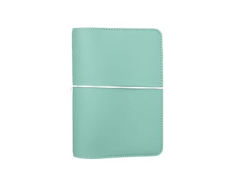 May include: A light blue leather notebook cover with a white elastic band.