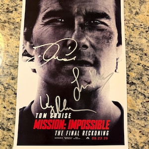 May include: A black and white film poster for Mission: Impossible - The Final Reckoning featuring a close-up portrait of Tom Cruise with three distinct signatures overlaid on the image. The text includes the title and the release date 05.23.25.
