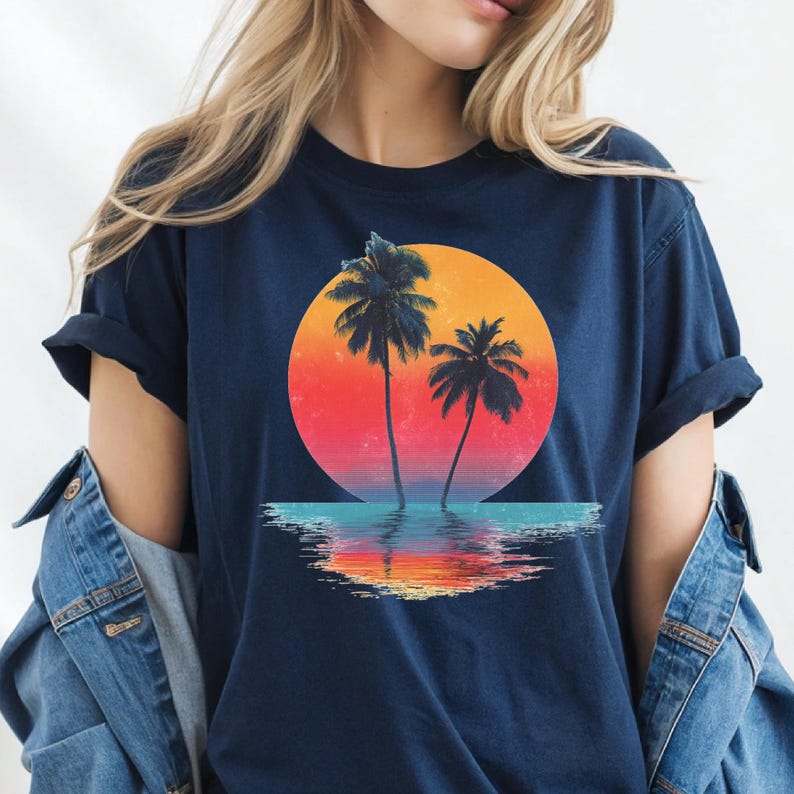 a woman wearing a t - shirt with a sunset and palm trees on it