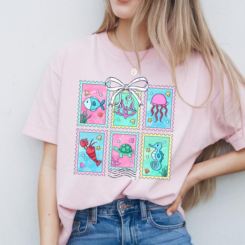 a woman wearing a pink t - shirt with a picture of an octopus on it