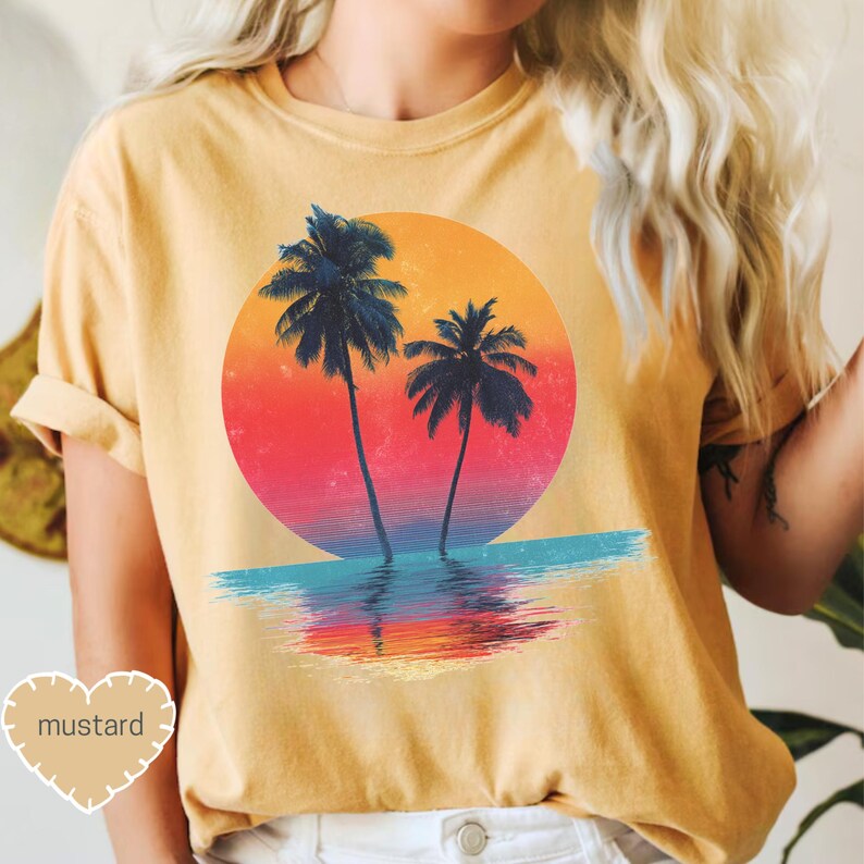 a woman wearing a t - shirt with a sunset and palm trees on it