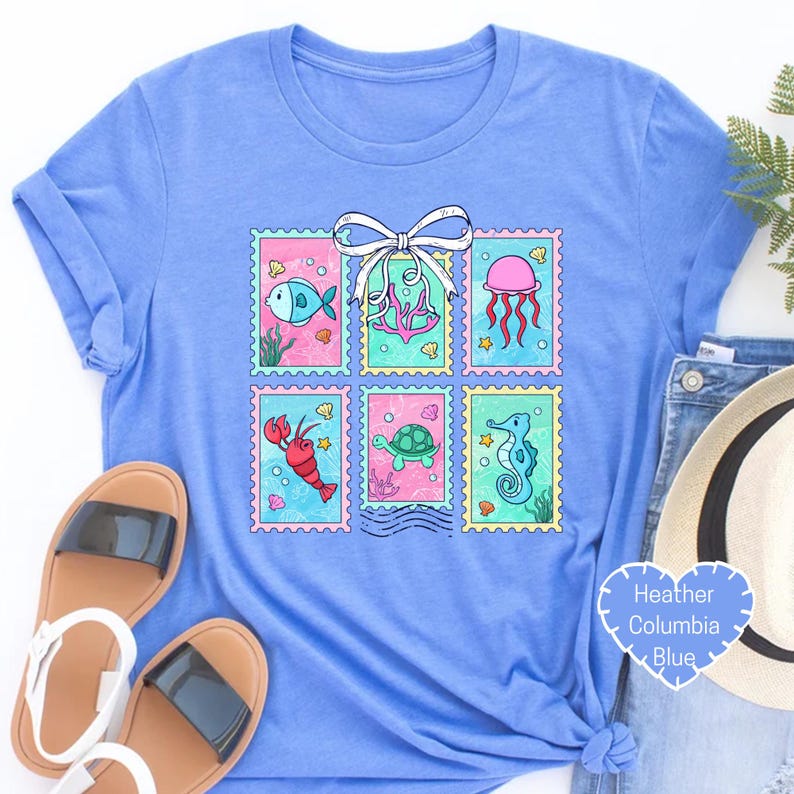 a blue t - shirt with a picture of a sea animal on it