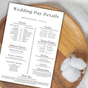 May include: A wedding day details card with the names Sebastian & Juliana and the date 05/02/25. The card includes a timeline, contacts, vendor contacts, additional details, and locations. The card is on a wooden tray.