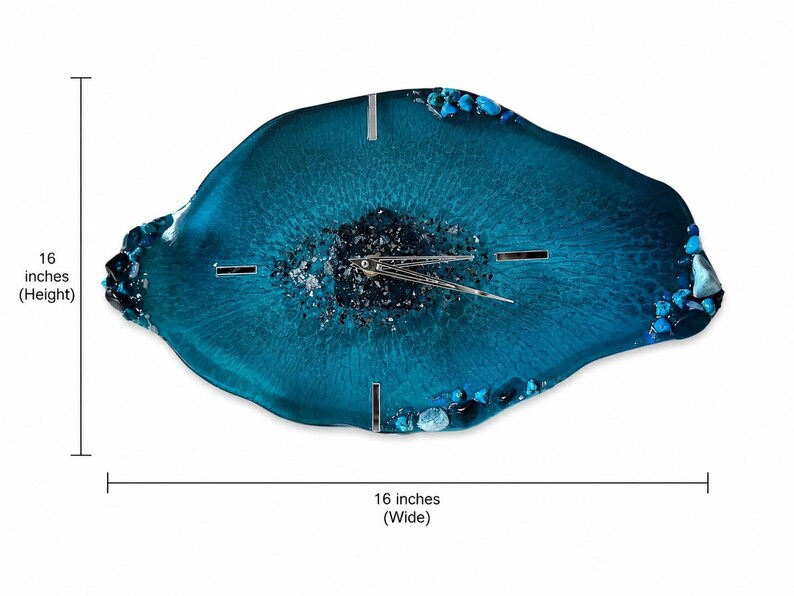 May include: An irregular, geode-inspired wall clock in shades of deep teal and blue resin. The center features dark crushed glass, surrounded by smooth resin and accented with blue stones along the edges. It measures 16 inches high by 16 inches wide.