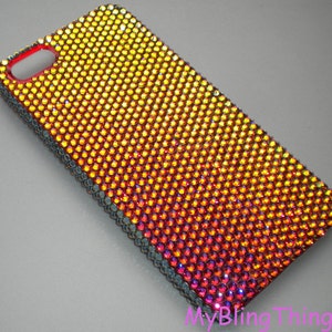May include: A phone case covered in iridescent rhinestones, with a gradient of red, orange, and yellow.