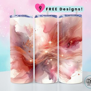 May include: Three stainless steel tumblers with lids and straws. The tumblers feature a watercolor design in shades of pink, red, and gold with a glittery effect. The text "9 FREE Designs!" is visible in the image.