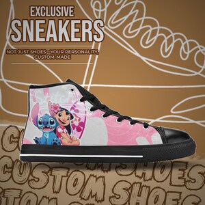 May include: High-top sneakers with a pink and white canvas upper featuring a cartoon image of Stitch and Lilo from Disney's Lilo & Stitch. The shoes have black laces, a black rubber sole, and a white trim around the sole. The text "EXCLUSIVE SNEAKERS" is at the top of the image, and the text "NOT JUST SHOES - YOUR PERSONALITY, CUSTOM-MADE" is below the image of the shoes.