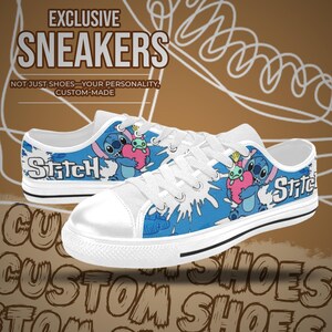 May include: White canvas trainers with a blue and white Stitch design. The word "Stitch" is printed on the side. The trainers have white laces and a black stripe on the sole. The text "EXCLUSIVE SNEAKERS" is visible.