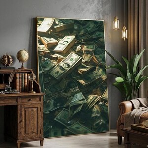 May include: A framed artwork featuring a close-up of stacks and piles of United States one hundred dollar bills. The artwork has a gold frame and is displayed in a room with a wooden desk and a leather armchair.