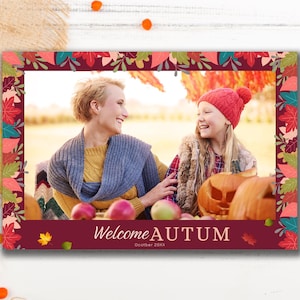 May include: A framed photograph with a burgundy border decorated with colourful leaves. The image shows two smiling people, pumpkins, and apples. The text "Welcome AUTUM" is displayed, creating an autumnal theme.