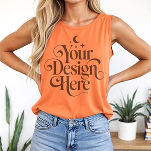 May include: A bright orange sleeveless tank top with a brown graphic that says "Your Design Here" with a crescent moon and stars above the text.