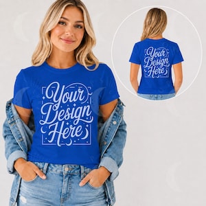 May include: A royal blue short-sleeve t-shirt featuring the white text "Your Design Here" in a decorative script font, framed by a rectangular border with small star and moon accents. The shirt is worn under a light blue denim jacket.