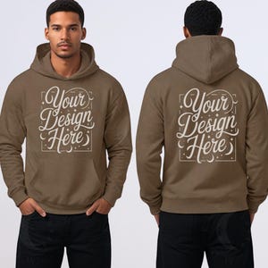 May include: A brown hoodie with the text "Your Design Here" in a decorative font on the front and back. The hoodie has a hood, a front pocket, and long sleeves. The person is wearing black pants.