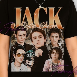 May include: Black t-shirt featuring a vintage-style graphic of Jack Dylan Grazer. The design includes the name "JACK" in gold lettering above a collage of images of the actor. The shirt is a classic crew neck.
