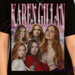 May include: Black t-shirt featuring a vintage-style graphic of Karen Gillan with a pink and white text overlay. The design includes multiple images of Gillan with a lightning bolt background.