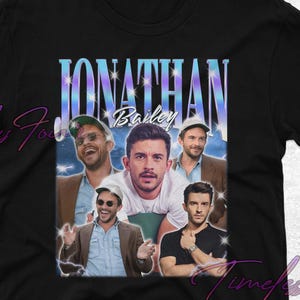 May include: Black t-shirt featuring a collage of images of a man, with the name "Jonathan Bailey" in a stylized font. The design includes a gradient background and multiple photos of the same person.