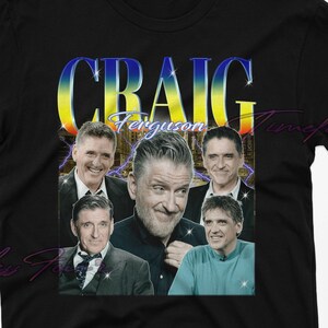 May include: Black t-shirt featuring a graphic of Craig Ferguson with the name "CRAIG" in a colorful, retro font. The design includes multiple images of Ferguson. A vintage-style tee.