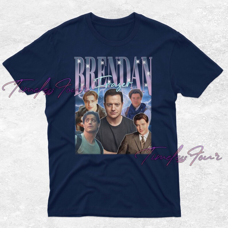 May include: Navy blue t-shirt featuring a collage of images of Brendan Fraser, with the name "Brendan Fraser" in a stylized font. The design includes multiple photos of the actor against a blue and purple background.