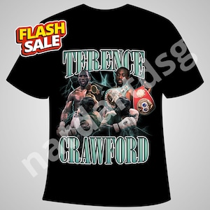 May include: Black t-shirt with a graphic of boxer Terence Crawford, championship belts, and the text "TERENCE CRAWFORD". A "FLASH SALE" sticker is in the upper left corner. The design includes lightning bolts.