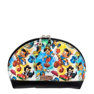 May include: A half-moon shaped black and white cosmetic bag with a zipper closure. The bag is covered in a colorful print of Pinocchio characters, including Geppetto, Jiminy Cricket, and Figaro the cat.