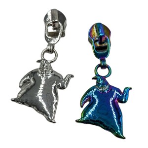 May include: Two zipper pulls featuring a cartoon character from the movie The Nightmare Before Christmas. One pull is silver and the other is iridescent.