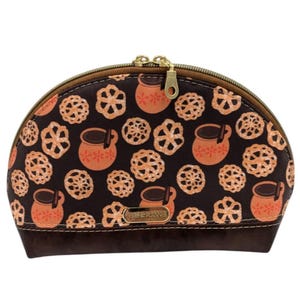 May include: A brown half-moon shaped zippered pouch with a brown and orange pattern of mugs and cookies. The pouch has a gold zipper and the text "Coffee & Cookies" is printed on the front.
