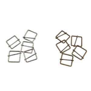 May include: Two sets of metal slider buckles. One set is silver and the other is bronze.