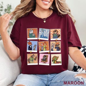 Pode incluir: Camiseta bord&ocirc; com uma grade de nove imagens de personagens de desenhos animados em estilo polaroid, cada uma com uma estrela. A palavra "MAROON" est&aacute; impressa no canto inferior direito. A camiseta &eacute; de cor vermelho escuro.