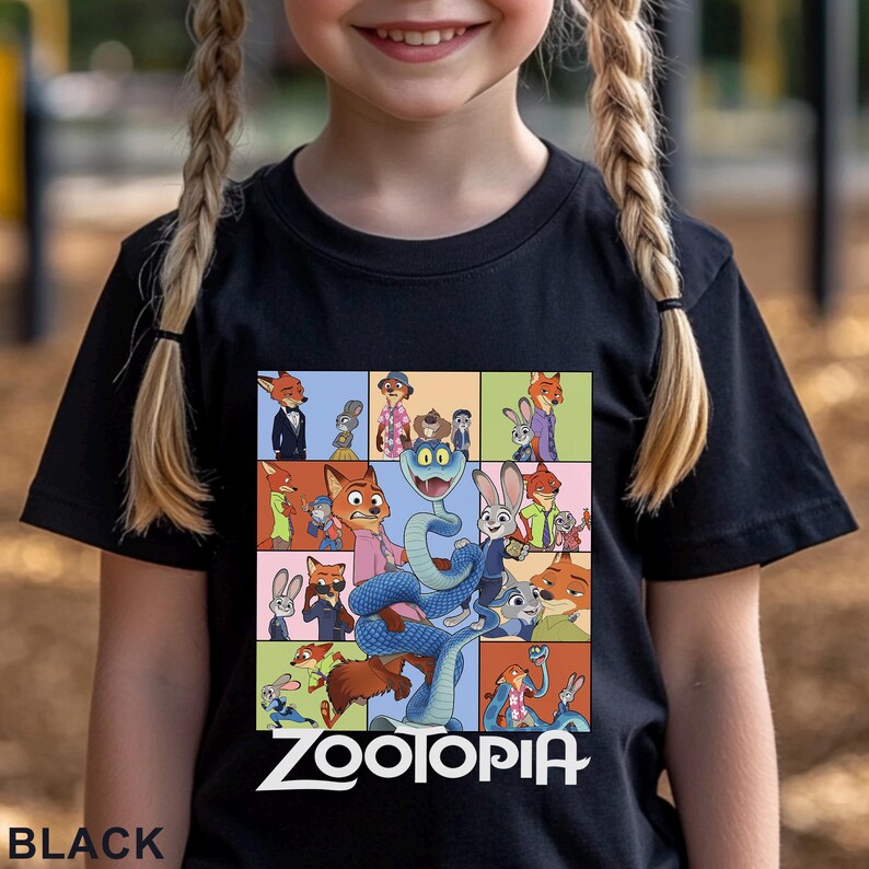 May include: A black short-sleeved t-shirt featuring a colourful grid graphic of various animated characters from the movie Zootopia, including a large blue snake in the centre. The word Zootopia is printed in white text below the graphic.