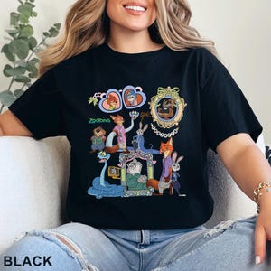 May include: Black t-shirt featuring a colorful graphic of characters from the animated film "Zootopia." The design includes various animal characters in a cartoon style, with the word "Zootopia" printed in green. The shirt is a casual wear item.