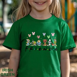 May include: Green t-shirt with a cartoon graphic of characters and the word "FRIENDS" in colourful letters. The shirt has a crew neck and short sleeves. The text "IRISH GREEN" is at the bottom.