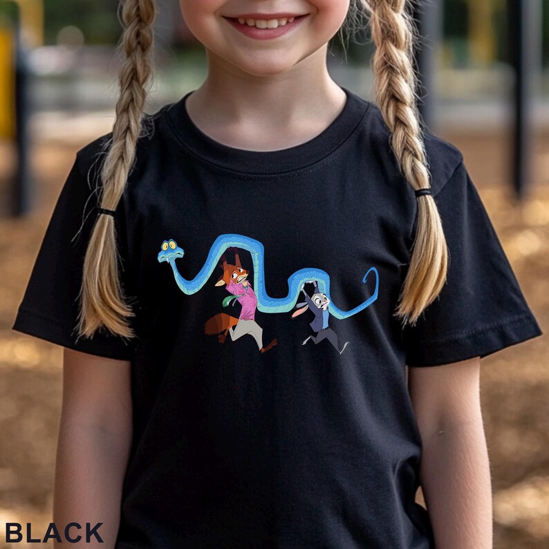 May include: A black short-sleeved t-shirt featuring a graphic print of a long, winding blue snake wrapping around two cartoon characters. The characters include a fox wearing a pink shirt and a rabbit wearing a blue jacket. The word BLACK is printed.