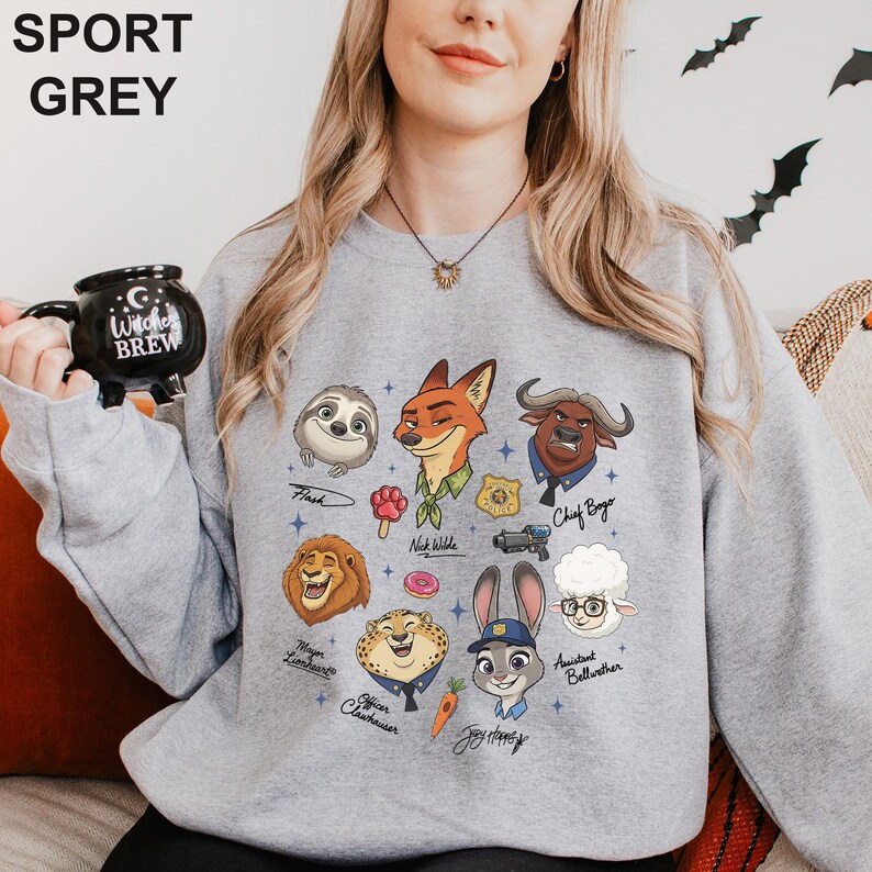 May include: Sport grey sweatshirt with cartoon characters from a popular animated film. The design includes characters like Flash, Nick Wilde, Chief Bogo, and Judy Hopps. The sweatshirt also has the text "SPORT GREY" at the top.