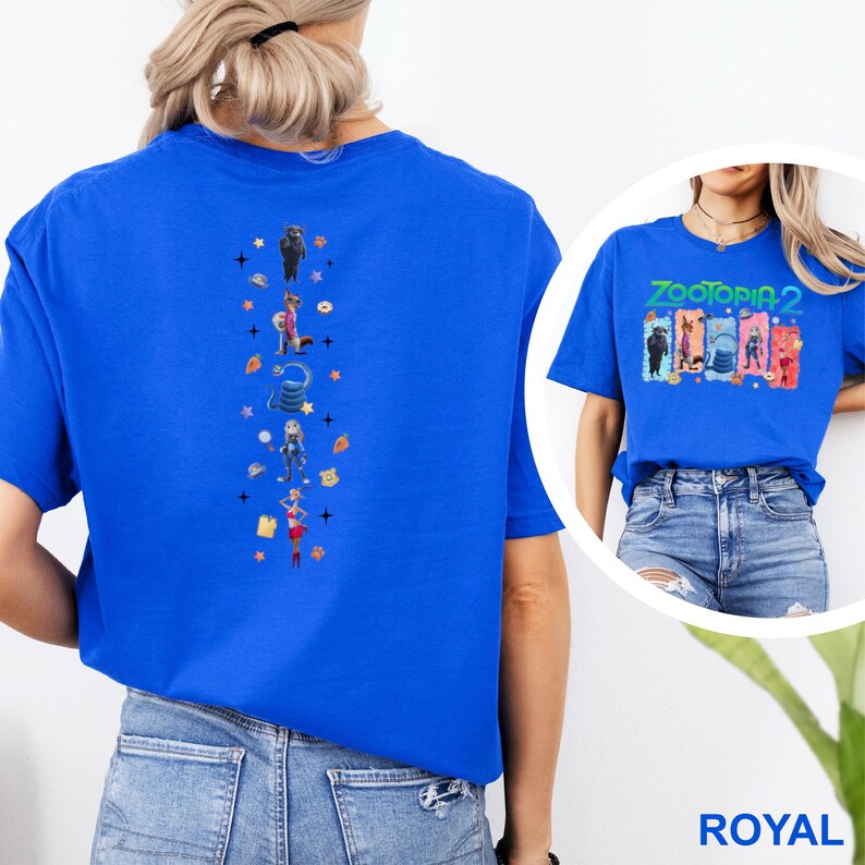 May include: Royal blue t-shirt featuring a vertical design of cartoon characters and stars. The front of the shirt has the text "ZOOTOPIA 2" with cartoon characters. The shirt is made of a soft material.