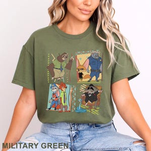 May include: Military green t-shirt with a vibrant graphic of animated film characters. The design is divided into four panels, each showcasing a different character. A comfortable, casual style.