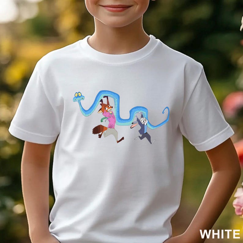 May include: A white short-sleeved t-shirt featuring a graphic print of a long blue snake winding around a cartoon fox wearing a pink shirt and a cartoon rabbit wearing a blue jacket. The characters appear to be running while being held by the snake.