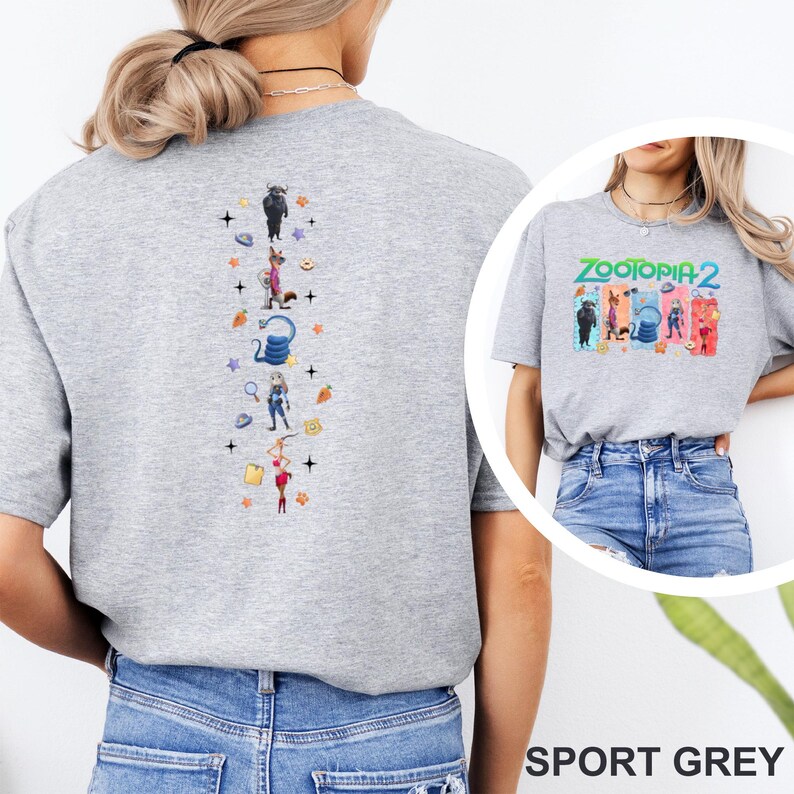 May include: Sport grey t-shirt featuring a colorful graphic of characters from Zootopia 2 on the front and a vertical design on the back. The back design includes cartoon characters and other elements. The text "ZOOTOPIA 2" is on the front.