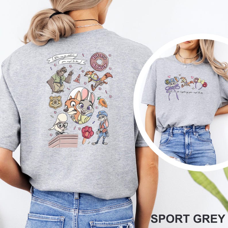 May include: A sport grey t-shirt featuring a back graphic with various cartoon animal characters, a donut, a badge, a carrot, and a paw-shaped popsicle. The text reads, "You can be whatever you wish to be." A smaller version of the graphic is on the front.