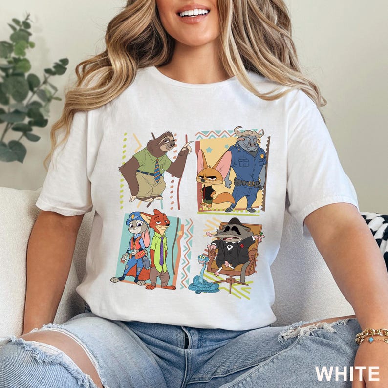 May include: White t-shirt with a cartoon design featuring characters from the film Zootropolis. The design includes a sloth, a fox, a buffalo, a rabbit, a fox, and a raccoon. The word "WHITE" is printed at the bottom right.