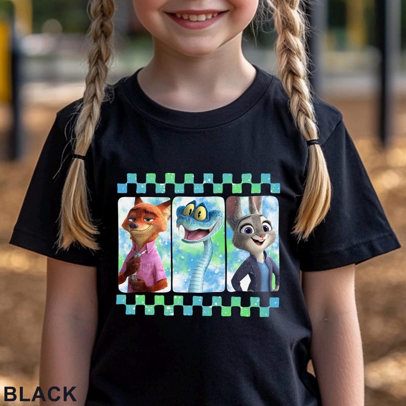 May include: Black t-shirt featuring three cartoon characters: a fox in a pink shirt, a blue snake, and a rabbit in a blue jacket. The design is framed by a checkered pattern in blue and green. The word "BLACK" is printed at the bottom.