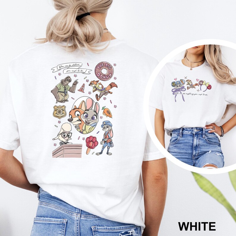 May include: A white t-shirt featuring a back graphic with various cartoon characters, a badge, a donut, and a carrot, along with the text "You can be whatever you wish to be." The front chest area displays a smaller graphic of character ears.