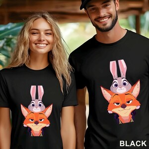 May include: Black t-shirts with a cartoon illustration of a fox and a rabbit. The fox is orange and the rabbit is grey, with the text "BLACK" at the bottom of the image.