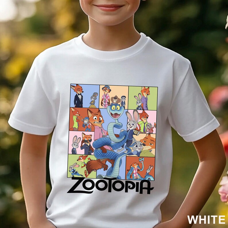 May include: A white short-sleeved t-shirt featuring a graphic print of various characters from the movie Zootopia arranged in a grid pattern. The design includes a large blue snake in the centre and the text Zootopia printed in black below.