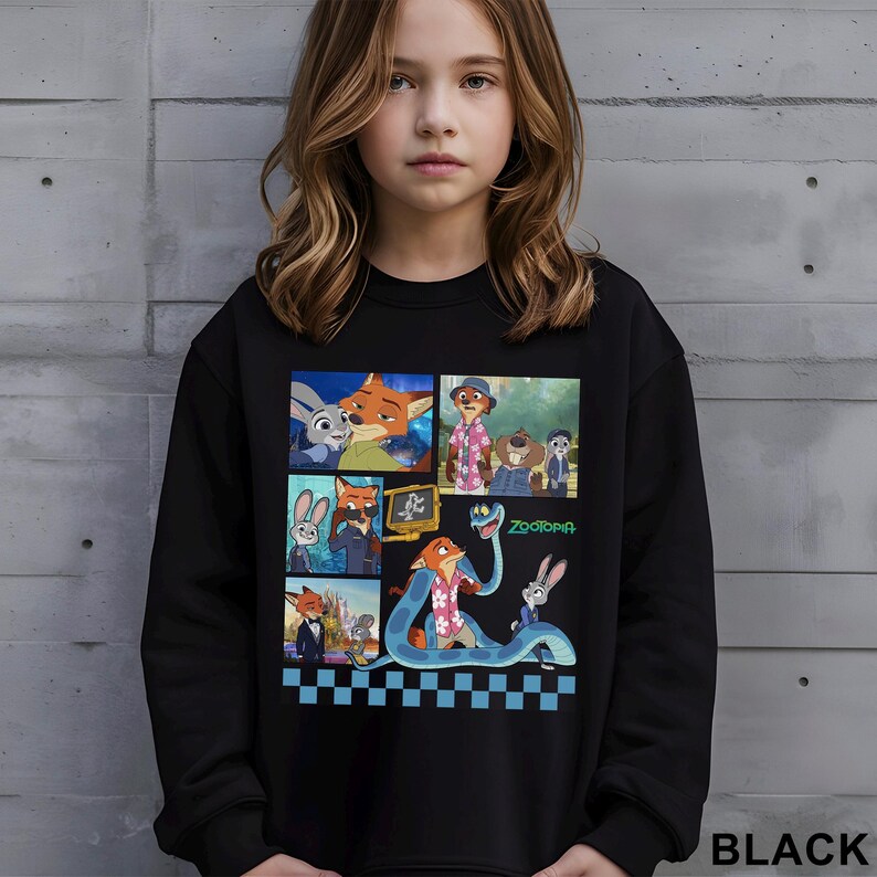 May include: Black sweatshirt featuring a colorful graphic of characters from the animated movie Zootopia. The design includes images of a fox, a bunny, and other characters. The word "Zootopia" is also visible. The sweatshirt is worn by a young person.