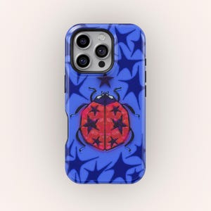 May include: A blue phone case featuring a red ladybug design with black star accents. The ladybug is centered on a background of blue starburst shapes. The case has a glossy finish and a protective bumper.